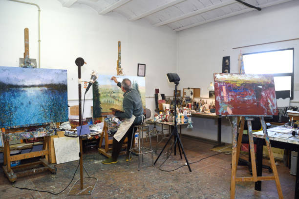 istock Painter artist painting a picture in the studio 933480158