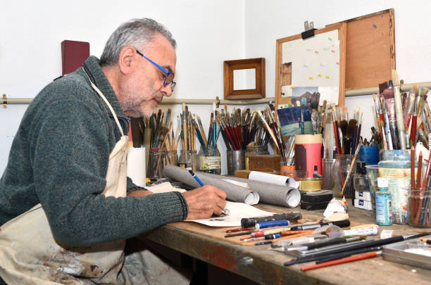 istock Painter artist painting a picture in the studio 933480442