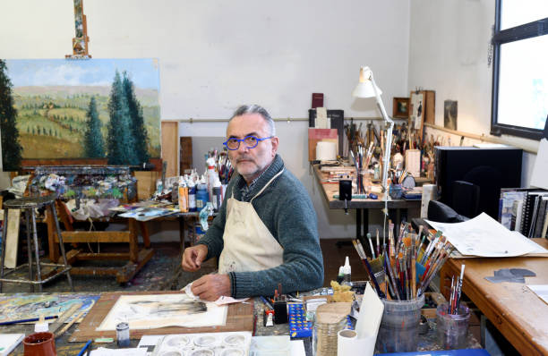 istock Painter artist painting a picture in the studio 933480444