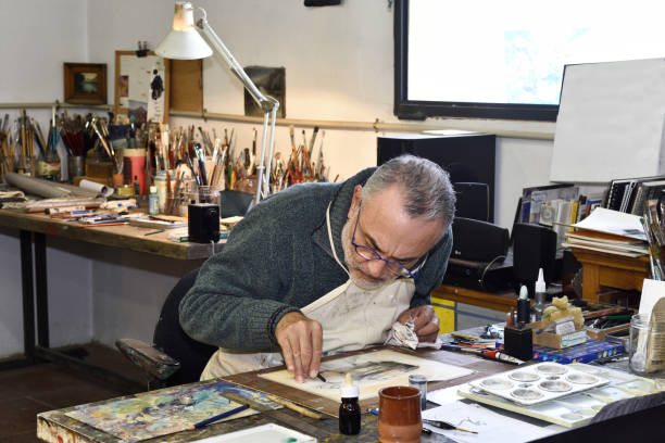 istock Painter artist painting a picture in the studio 933482522