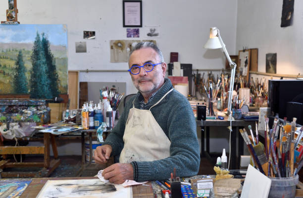 istock Painter artist painting a picture in the studio 933483622
