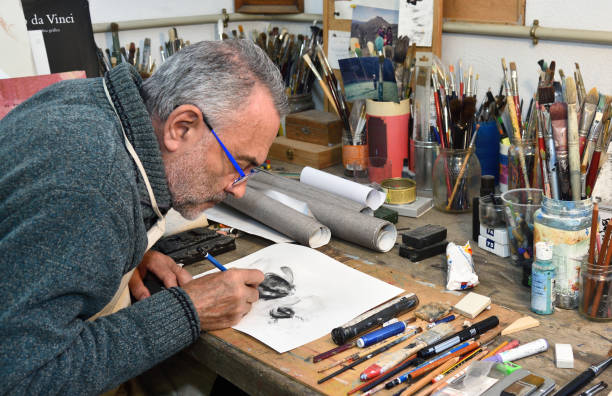 istock Painter artist painting a picture in the studio 933483624