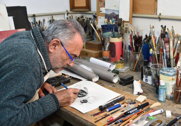 istock Painter artist painting a picture in the studio 933483626