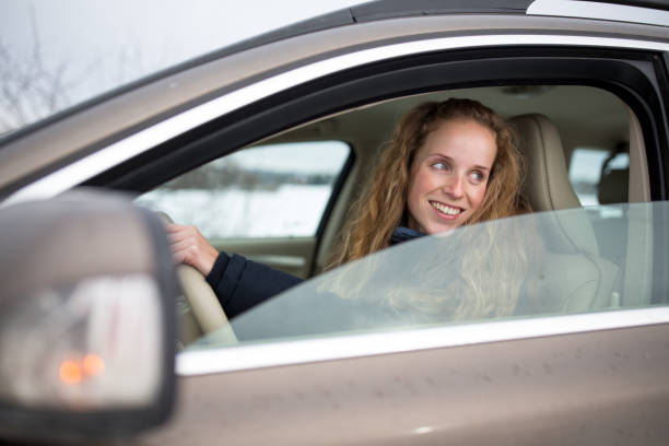 istock Pretty young woman driving her new ca 933484202
