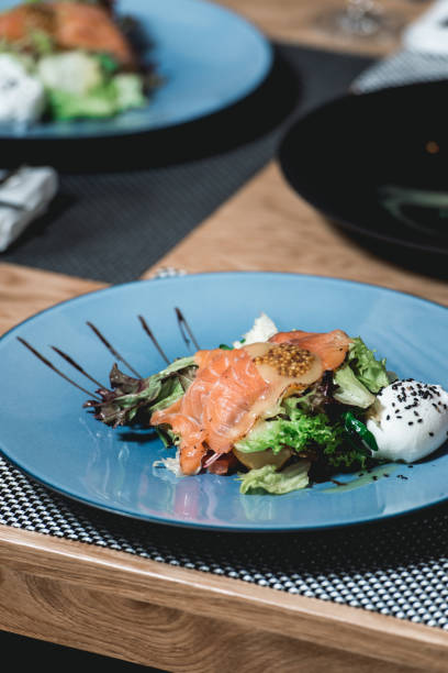 istock delicious salmon salad with egg in a restaurant. small portion 933497340