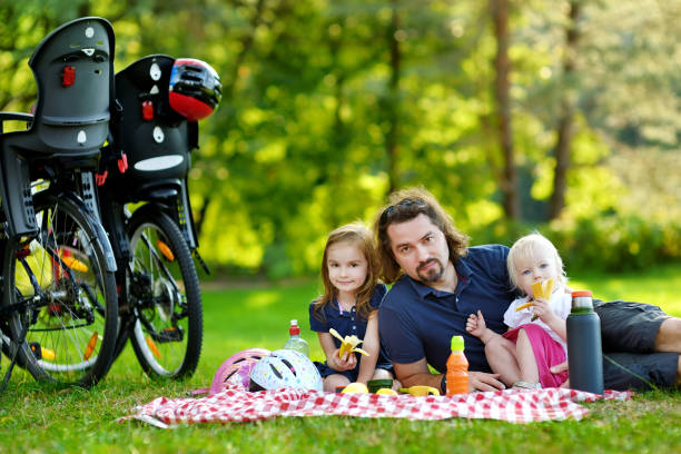 istock Young father and his daughters having a picnic 933502280