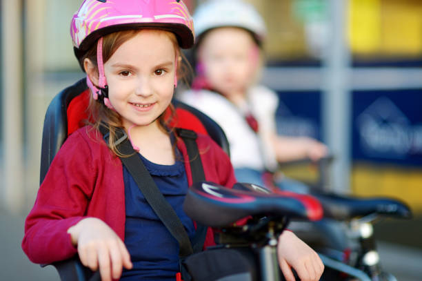 istock Two little sisters ready to ride a bike 933507240
