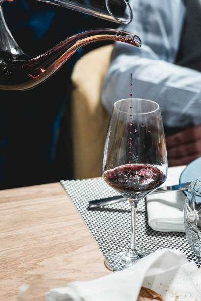 istock sommelier pouring champagne into glass at wine tasting 933507566