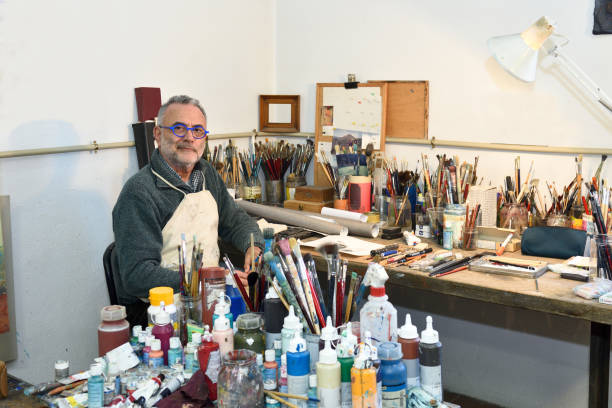 istock Painter artist painting a picture in the studio 933516458