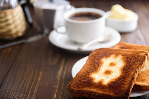 Breakfast with coffee and toasts. Toast with bitcoin symbol.