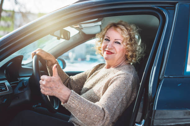 istock Happy senior lady in her car 933517392