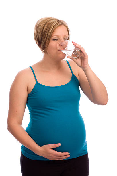 istock Young pregnant Caucasian woman drinking water 93351868