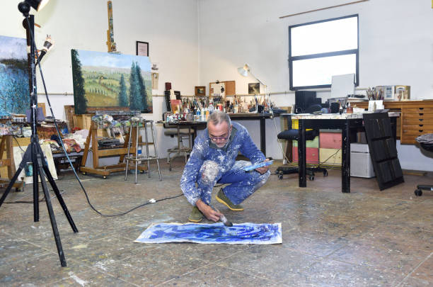 istock Painter artist painting a picture in the studio 933523056