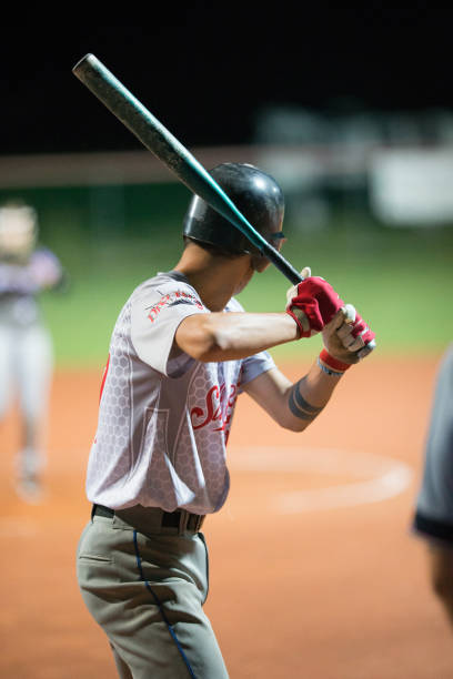 istock Softball Batter Preparing to Hit the Ball 933528406