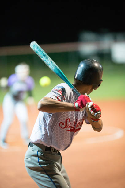 istock Softball Batter Preparing to Hit the Ball Mid Air 933528408