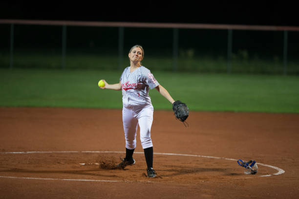 istock Female Softball Player Throwing the Ball 933528414
