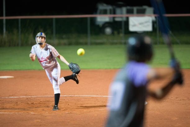 Softball Pitcher Throwing the Ball to Batter stock photo