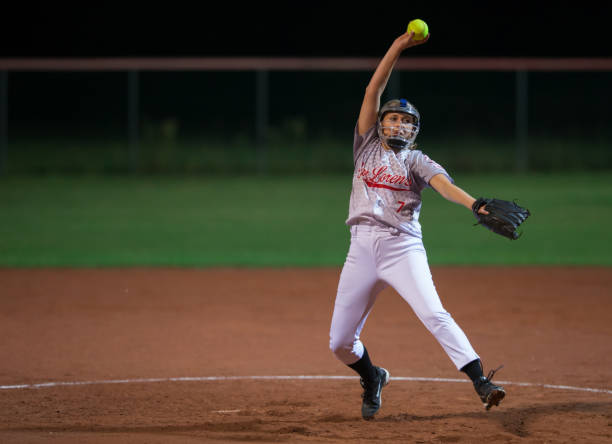 istock Softball Player Holding the Ball Arms Raised 933528450