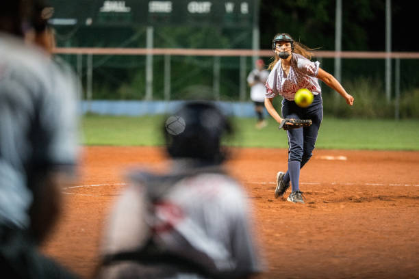 Softball Pitcher Looking at the Ball Mid Air stock photo