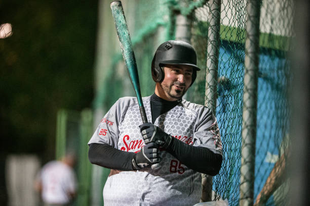 istock Happy Softball Batter Holding a Bat 933529666