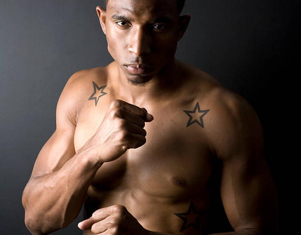 Face portrait, mma sports and man in studio on a blue background. Martial arts, body fitness and serious male fighter or boxer ready for training, workout or exercise for battle, match or competition