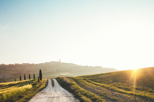 Tuscany landscape with country road leading to the village Pienza (Val D'orcia, Italy).
