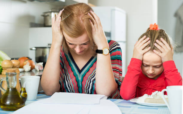 istock woman working from home, little daughter asking for attention 933580114
