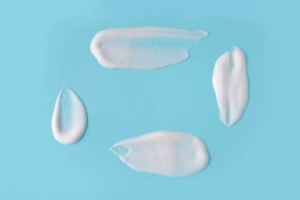istock Soap foam bubbles on blue background macro close up. 933582880