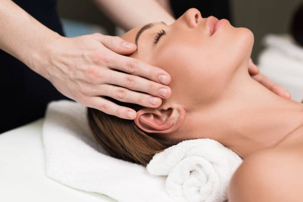 istock young woman relaxing and having head massage in spa salon 933583122