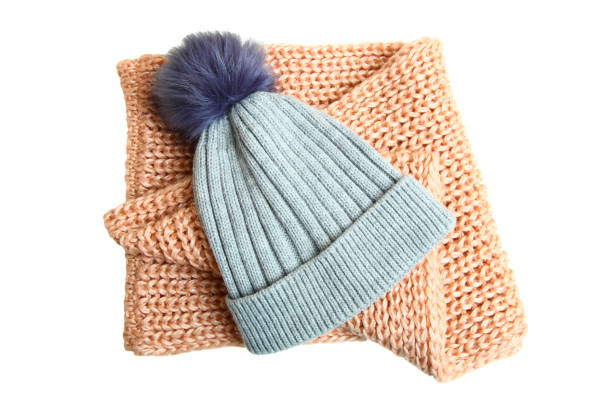 gray hat with a pompon and a knitted scarf