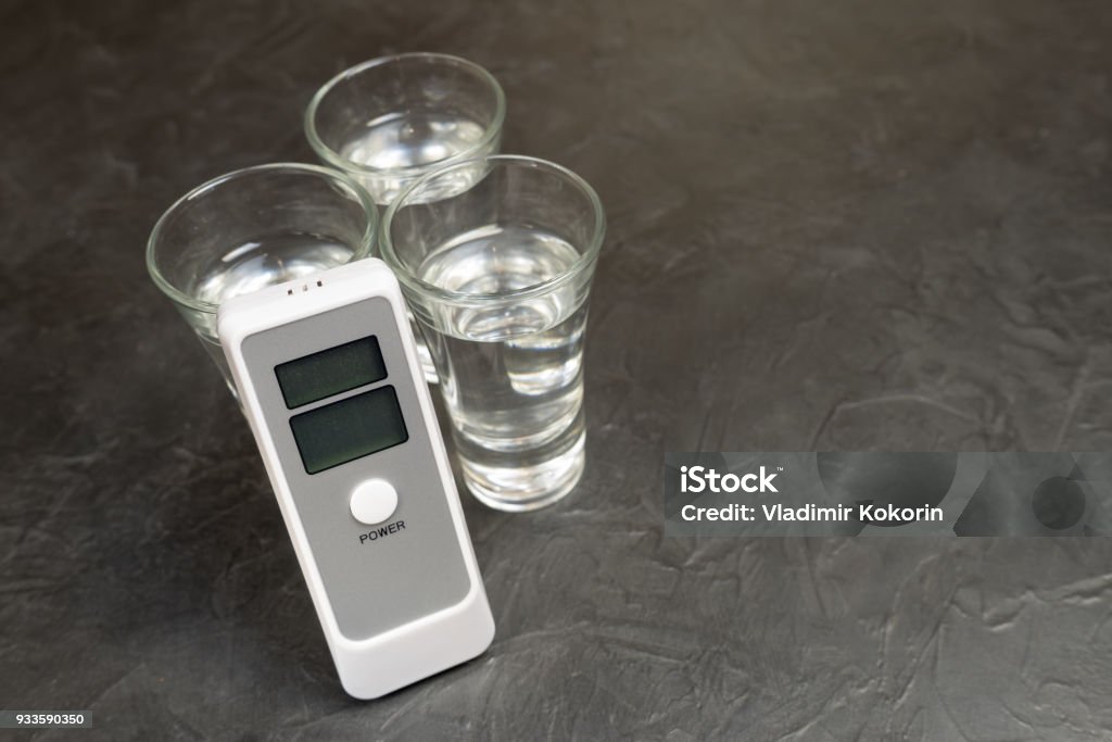 Device for measuring the degree of intoxication. Device for measuring the degree of intoxication... Alcohol - Drink Stock Photo