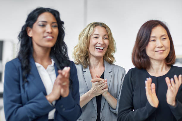 istock Happy businesswomen applauding in office 933591028