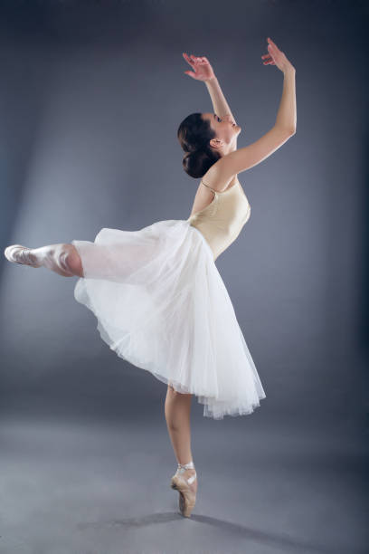 istock Beautiful slim woman ballet dancer in studio isolated on gray 933594498