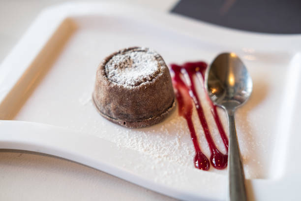 istock Chocolate lava on plate, with sauce and spoon 933594878