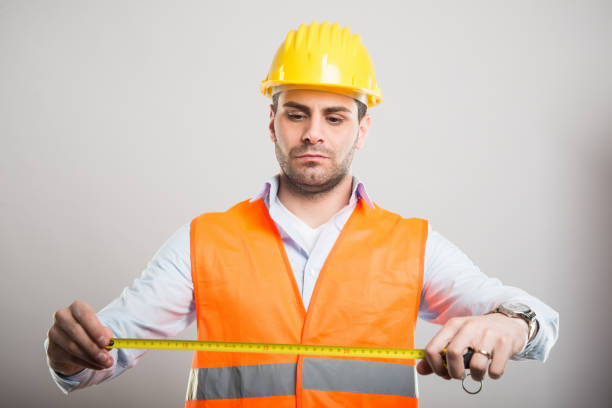 istock Portrait of handsome architect holding measuring roll 933602320