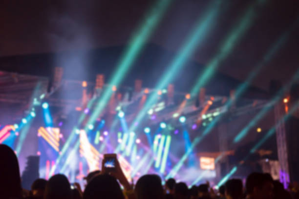 istock Blurred background : Bokeh lighting in outdoor concert with cheering audience 933615436