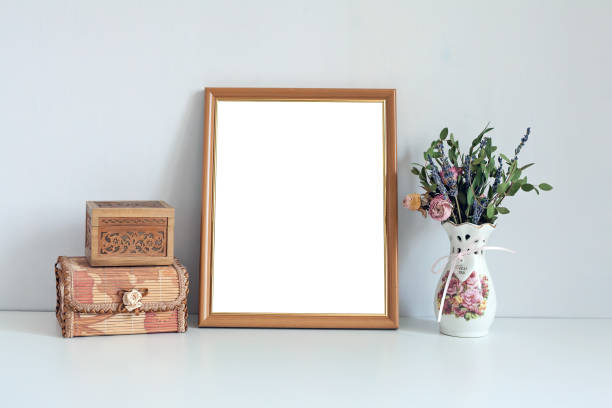 istock Mockup 8x10 wooden frame with boxes and flowers 933628774
