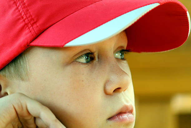 Vibrant portrait of a child in a blue hat and red hoodie, highlighting individuality, self-confidence, and the creative power of urban street culture.
