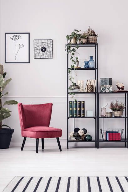 istock Burgundy armchair in white room 933630874