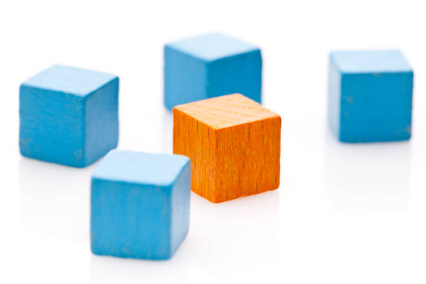 One cube in orange and many blue cubes