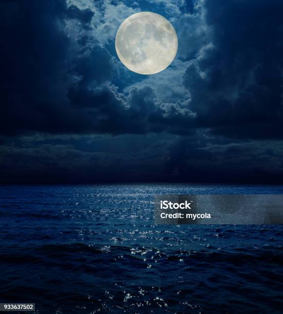 Super Moon In Dark Clouds Over Sea Stock Photo - Download Image Now - Moon, Night, Sea