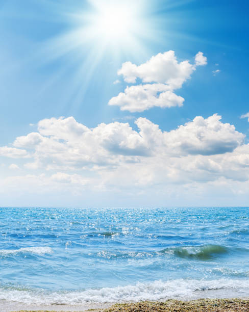 istock sea with blue water on beach and clouds in blue sky with sun 933638066