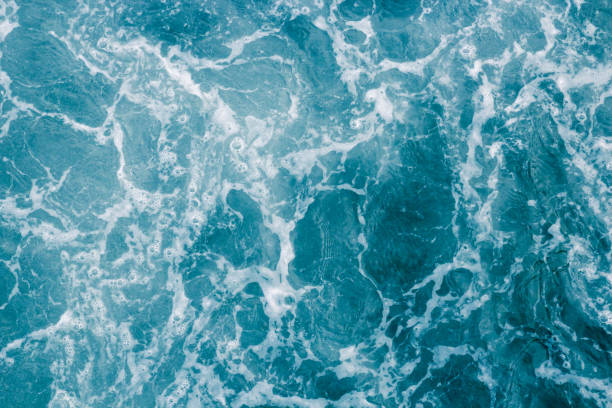 istock Abstract blue sea water with white foam and bubbles for background, nature background concept 933640832