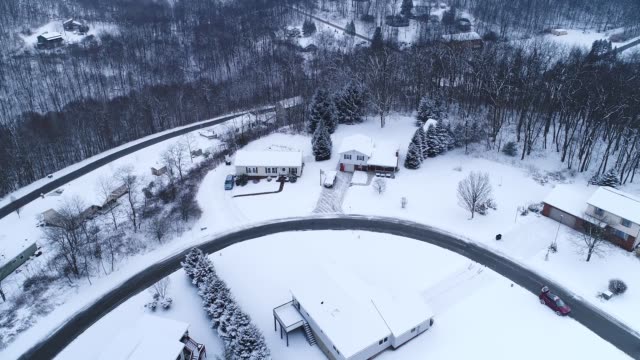 Forward Aerial Tilt Up View of Winter Residential Neighborhood