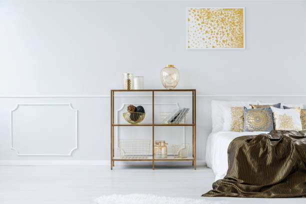 istock Gold and white bedroom interior 933647382
