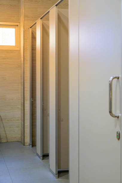 istock Clean public toilet room empty with big window and light from outside, restroom interior. 933648124