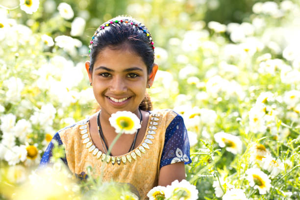 istock Girl in daisy flower field 933652594