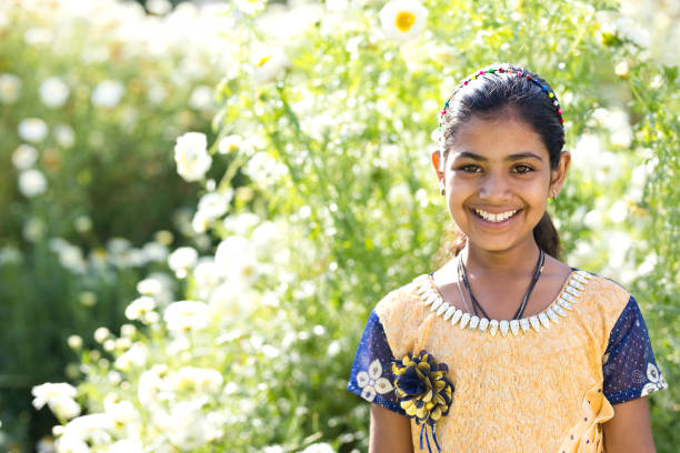istock Girl in daisy flower field 933652726