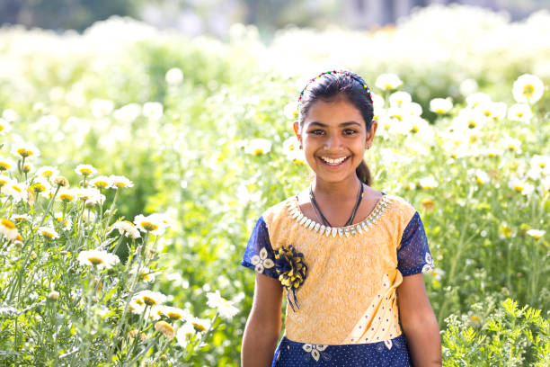 istock Girl in daisy flower field 933653164