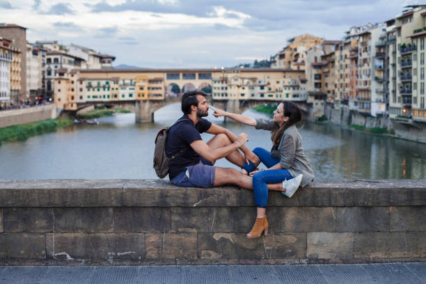 istock Couple at sunset in front of Ponte Vecchio, Florence 933653668